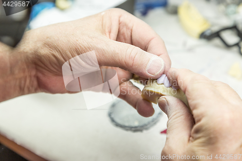 Image of Dental Technician Working On 3D Printed Mold For Tooth Implants