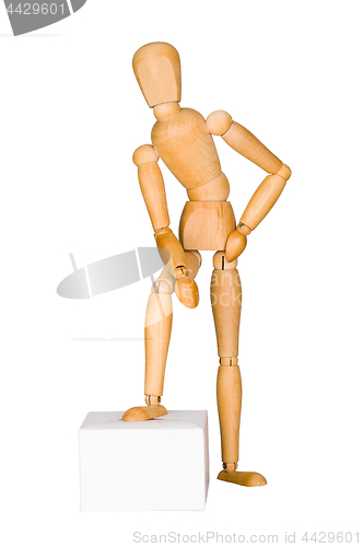 Image of Wooden mannequin lean on the box. 