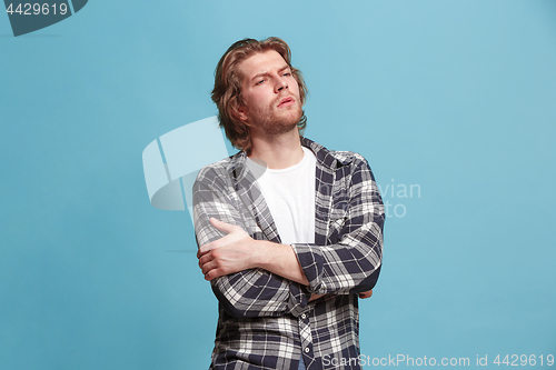 Image of Young serious thoughtful business man. Doubt concept.