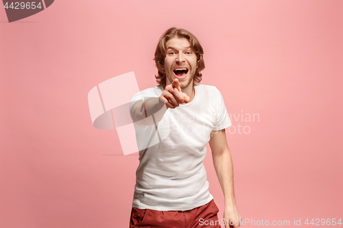 Image of The happy business man point you and want you, half length closeup portrait on pink background.
