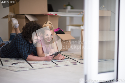 Image of Young couple moving in a new flat