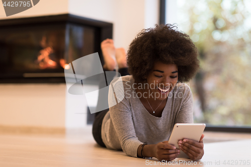Image of black women using tablet computer on the floor