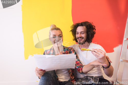 Image of Happy young couple relaxing after painting