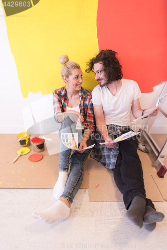 Image of Happy young couple relaxing after painting