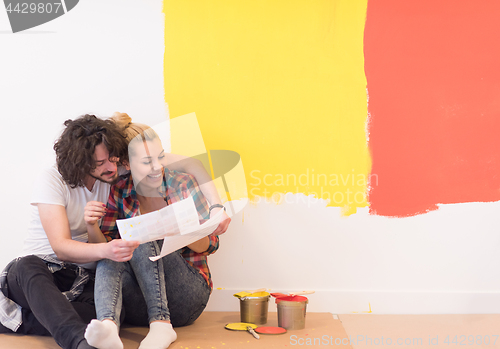 Image of Happy young couple relaxing after painting