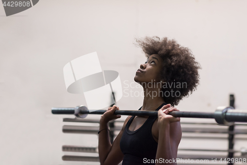 Image of black woman lifting empty bar