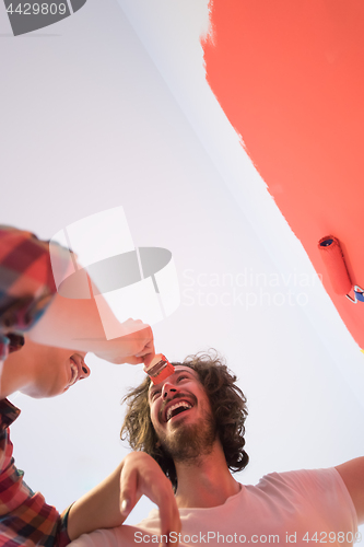 Image of couple painting interior wall