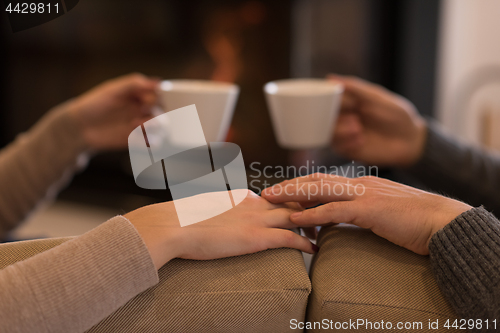 Image of Young couple  in front of fireplace