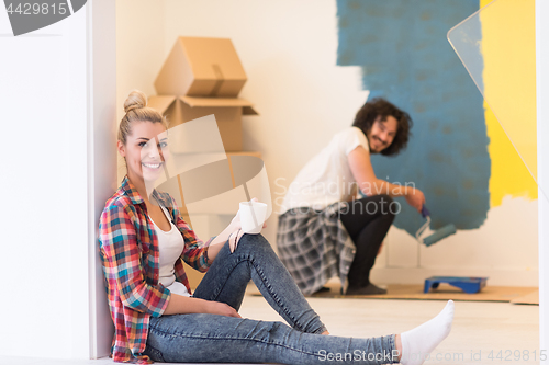 Image of young couple doing home renovations