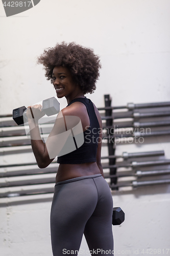 Image of black woman doing bicep curls