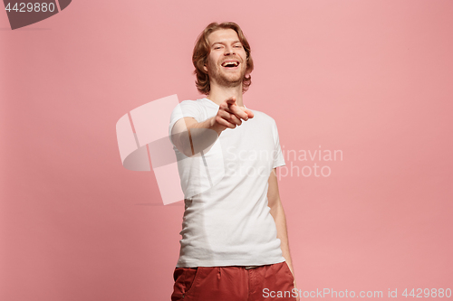 Image of The happy business man point you and want you, half length closeup portrait on pink background.