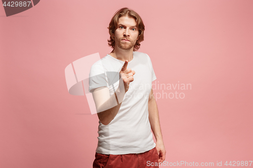 Image of The overbearing business man point you and want you, half length closeup portrait on pink background.