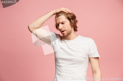 Image of Beautiful man looking suprised and bewildered isolated on pink