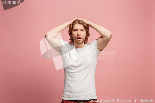Image of Beautiful man looking suprised isolated on pink