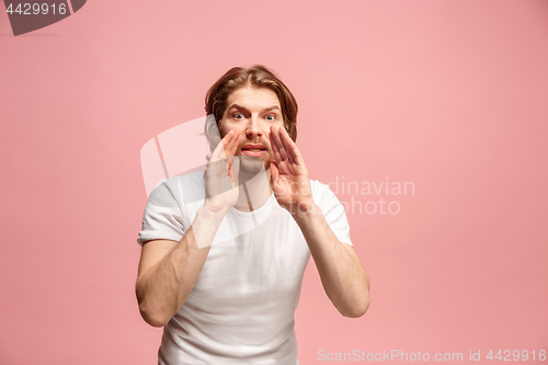 Image of Isolated on pink young casual man shouting at studio