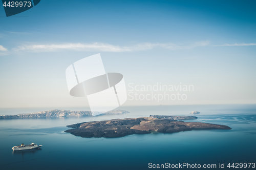 Image of Beautiful landscape with sea view. Cruise liner at the sea near the Nea Kameni, a small Greek island in the Aegean Sea near Santorini