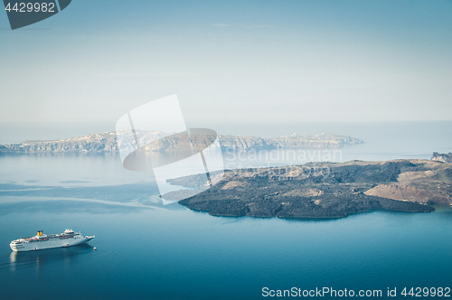 Image of Beautiful landscape with sea view. Cruise liner at the sea near the Nea Kameni, a small Greek island in the Aegean Sea near Santorini