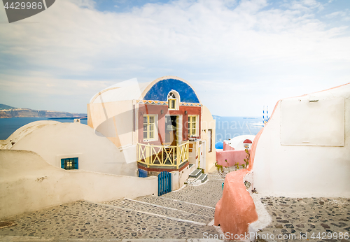 Image of Typical colorful narrow street in Oia the most beautiful village of Santorini island