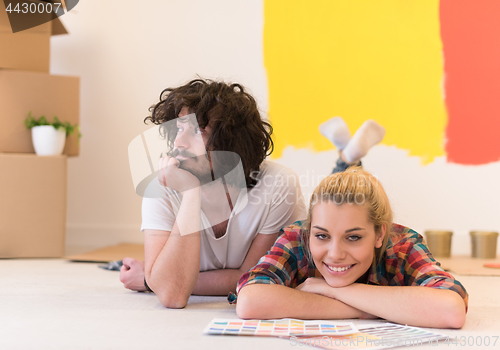 Image of Happy young couple relaxing after painting