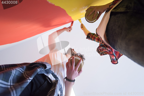 Image of couple painting interior wall