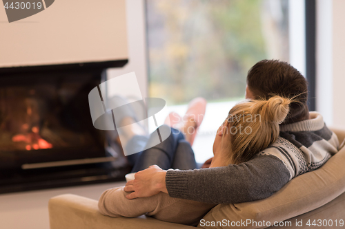 Image of Young couple  in front of fireplace
