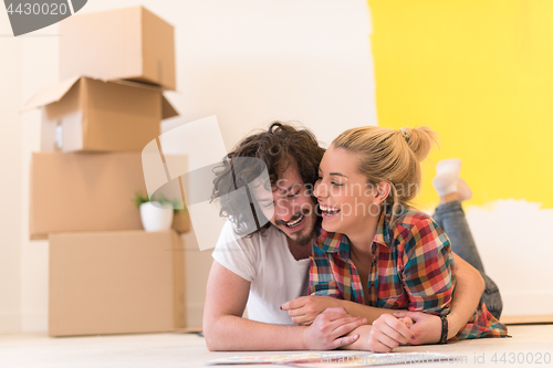 Image of Happy young couple relaxing after painting