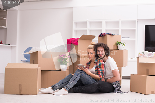 Image of young couple moving  in new house