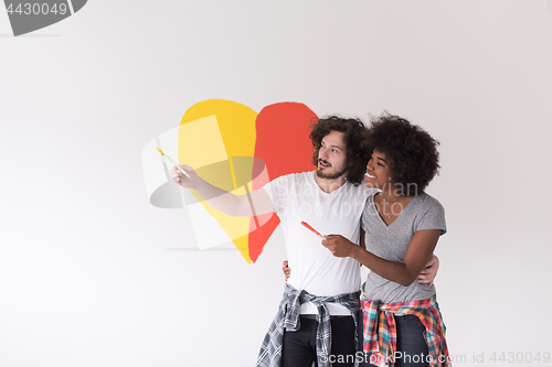 Image of couple with painted heart on wall