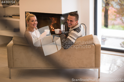 Image of Young couple  in front of fireplace