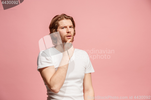 Image of Young serious thoughtful business man. Doubt concept.