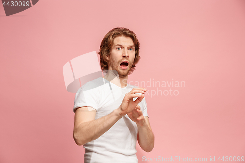 Image of Portrait of the scared man on pink