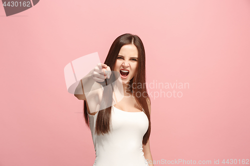 Image of The overbearing business woman point you and want you, half length closeup portrait on pink background.