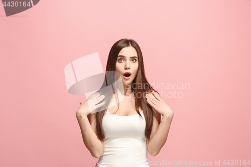 Image of Beautiful woman looking suprised isolated on pink