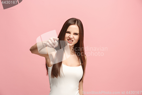 Image of The overbearing business woman point you and want you, half length closeup portrait on pink background.