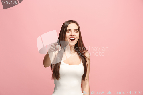 Image of The happy business woman point you and want you, half length closeup portrait on pink background.