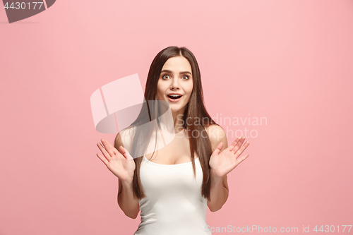 Image of Beautiful woman looking suprised isolated on pink