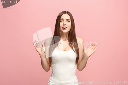 Image of Beautiful woman looking suprised isolated on pink