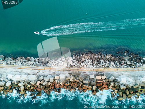 Image of A speed boat and a breakwall aerial view