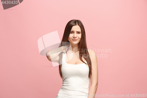 Image of Let me think. Doubtful pensive woman with thoughtful expression making choice against pink background