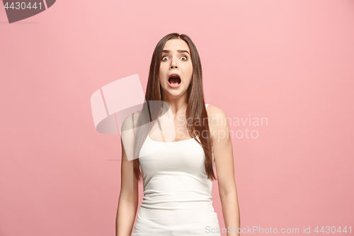 Image of Portrait of the scared woman on pink