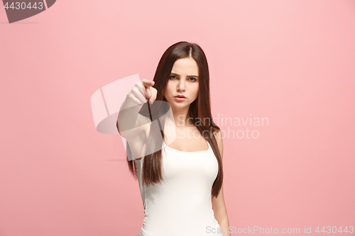 Image of The overbearing business woman point you and want you, half length closeup portrait on pink background.