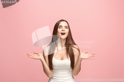 Image of Beautiful woman looking suprised isolated on pink