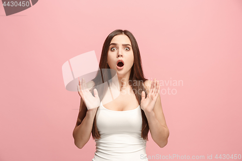 Image of Beautiful woman looking suprised isolated on pink