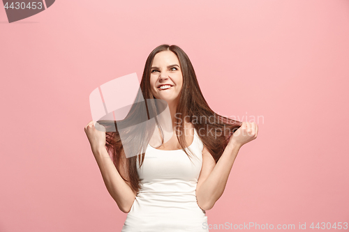 Image of The squint eyed woman with weird expression isolated on pink