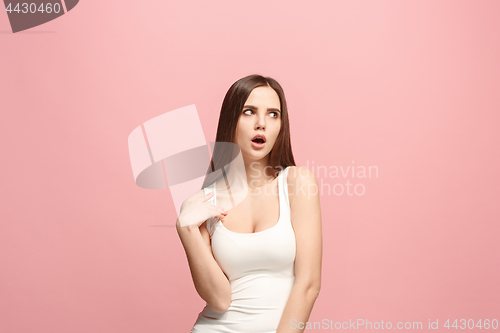 Image of Let me think. Doubtful pensive woman with thoughtful expression making choice against pink background