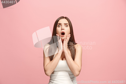 Image of Beautiful woman looking suprised isolated on pink