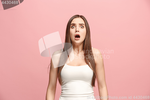 Image of Portrait of the scared woman on pink