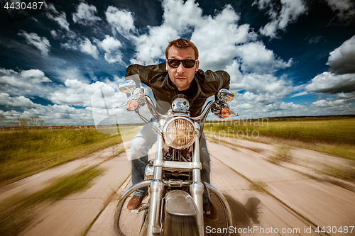 Image of Biker racing on the road