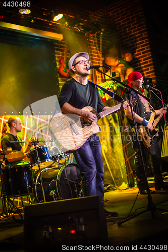 Image of Band performs on stage in a nightclub