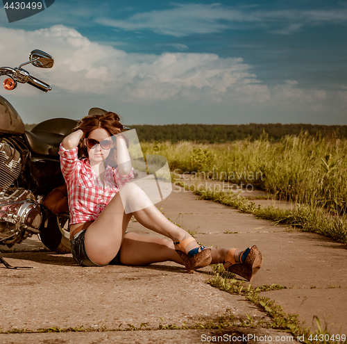 Image of Biker girl and motorcycle